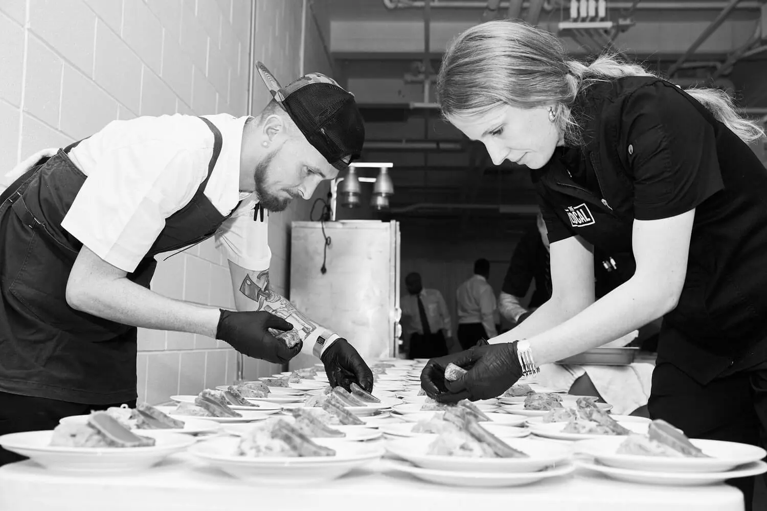 Chefs plating food together