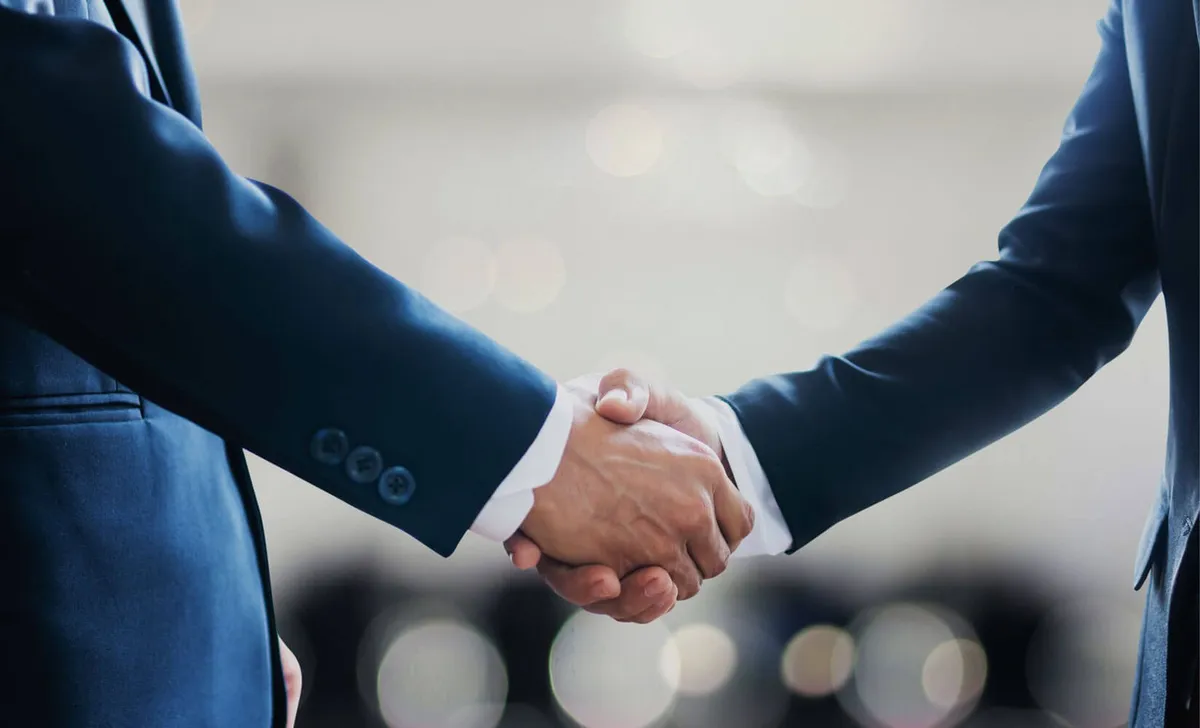 Two professionals shaking hands at a Baltimore wedding showing planner and caterer vendor coordination