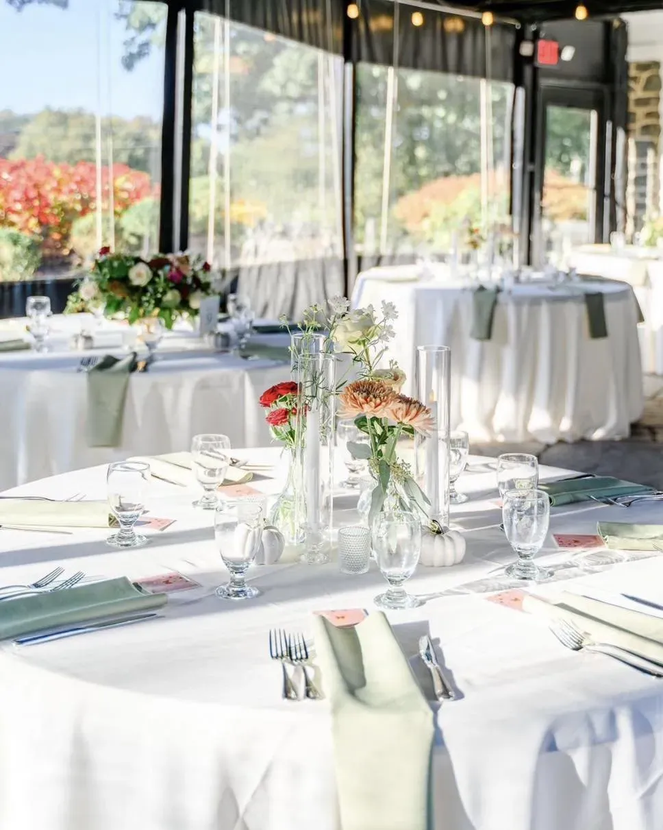 Round reception table set with florals, linens and glassware. Catering in Downtown Baltimore.