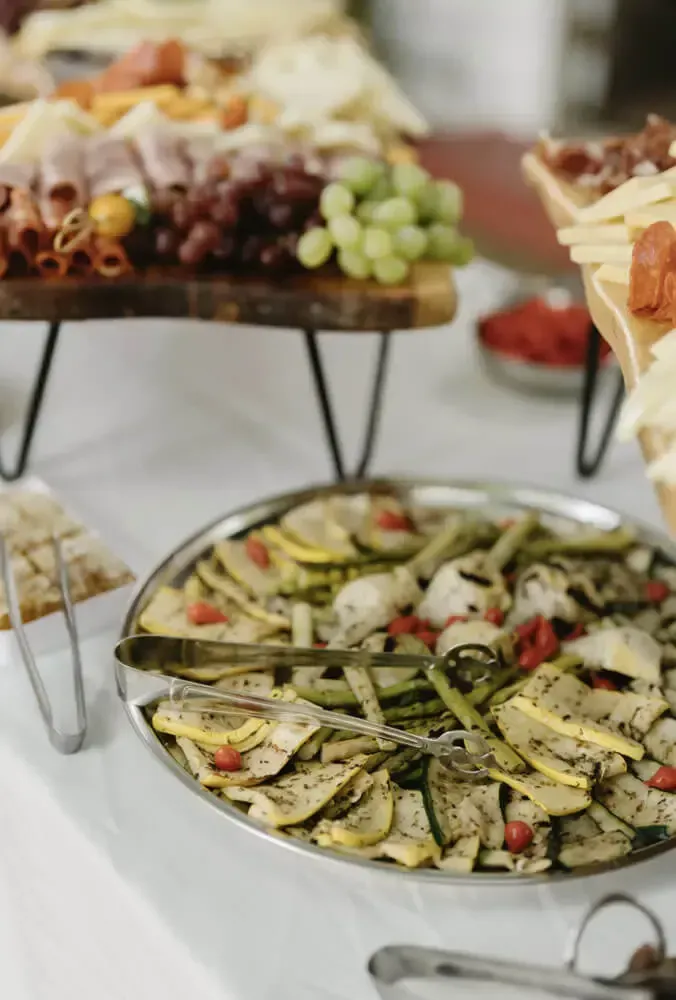 Grazing board with marinated vegetables and a charcuterie stand. Catering in Druid Hill Park, Baltimore.