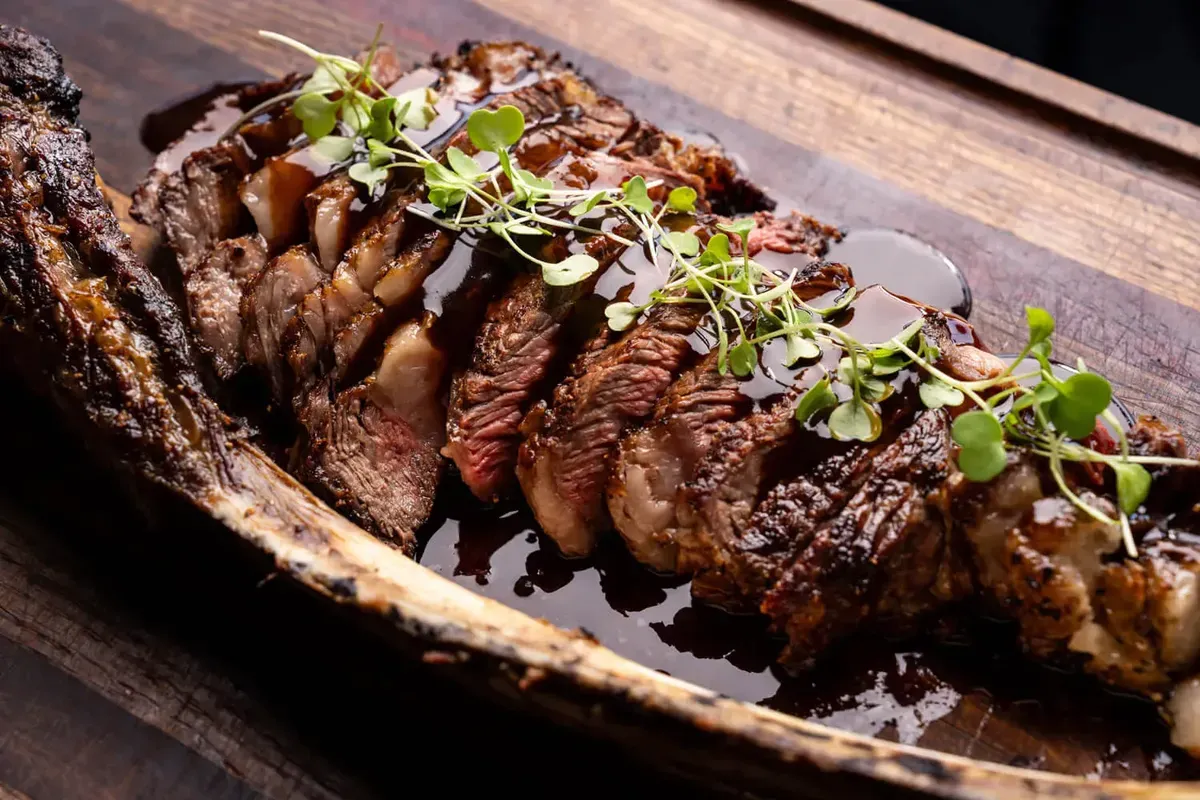 Sliced roast beef carved onto a wooden serving board. Catering in Greater Rosemont, Baltimore.