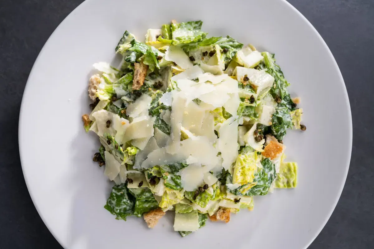 Plated Caesar salad with shaved parmesan served at a catered wedding in Baltimore