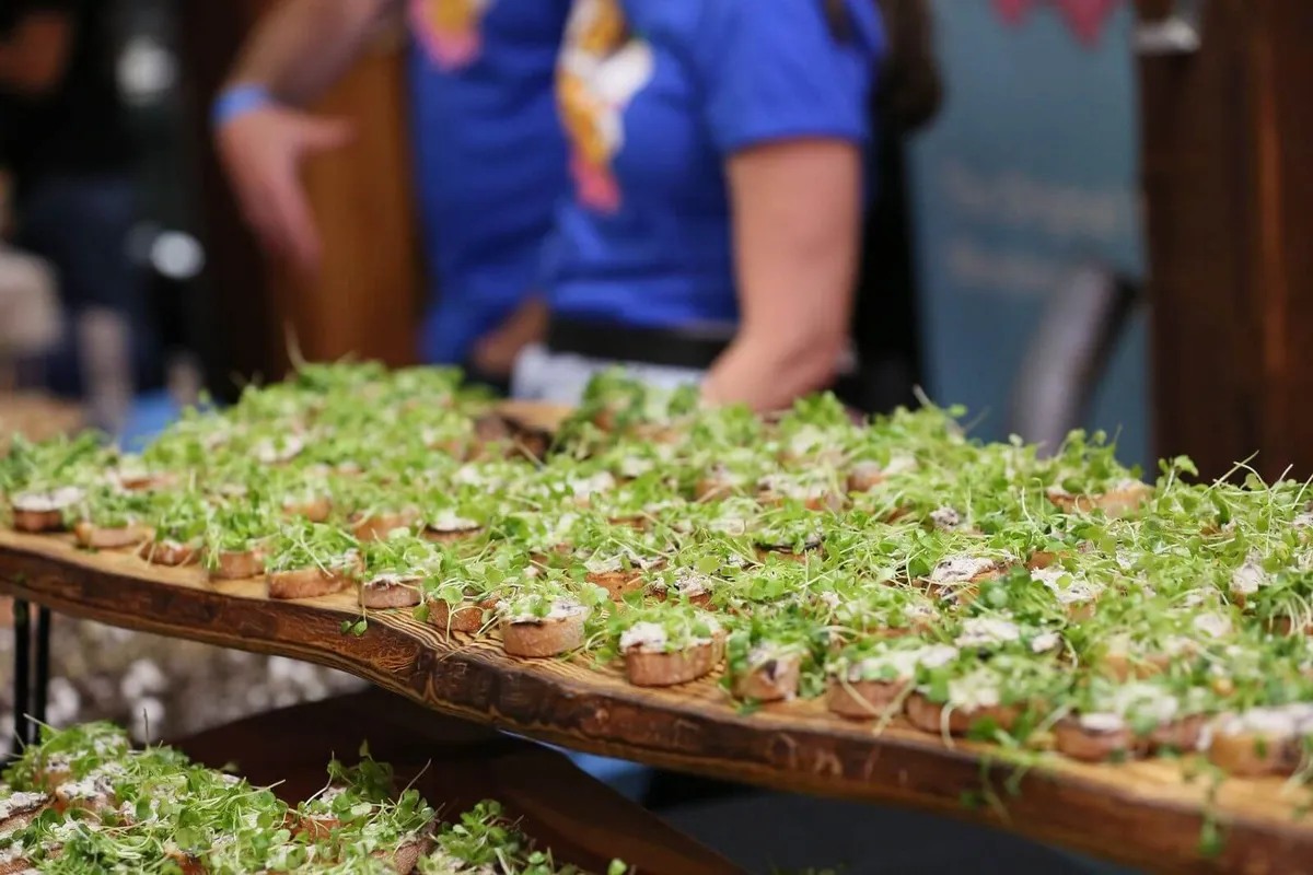 Rows of small appetizers topped with microgreens on a serving board in Baltimore