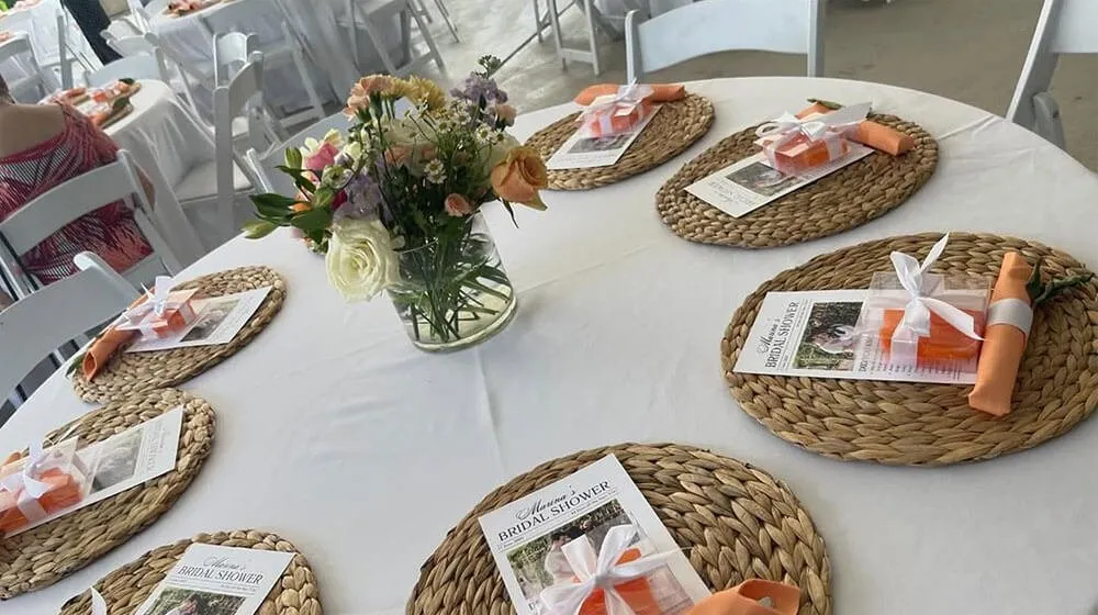 Round table set with place mats, favors and flowers for guests in Baltimore