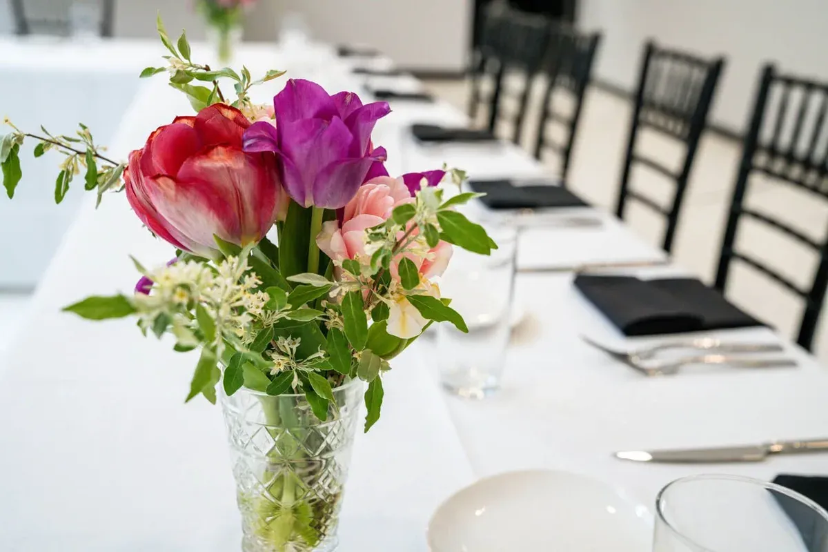 Long banquet table with flowers and place settings arranged for a confirmed guest count in Baltimore