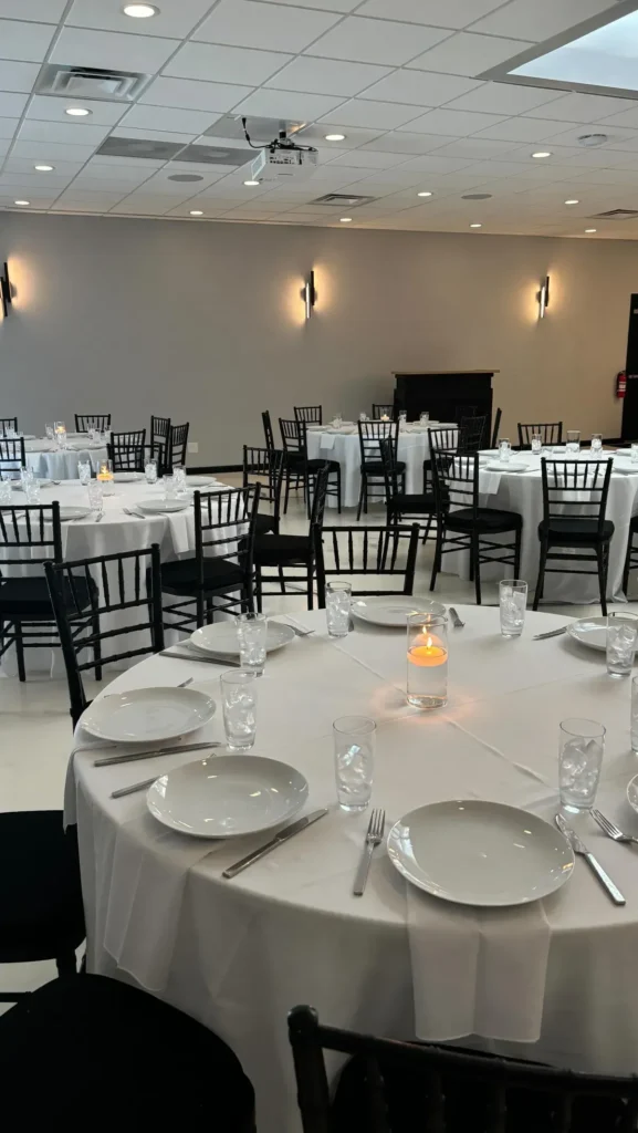 Round dinner table set with plates and glassware for a seated event in Baltimore