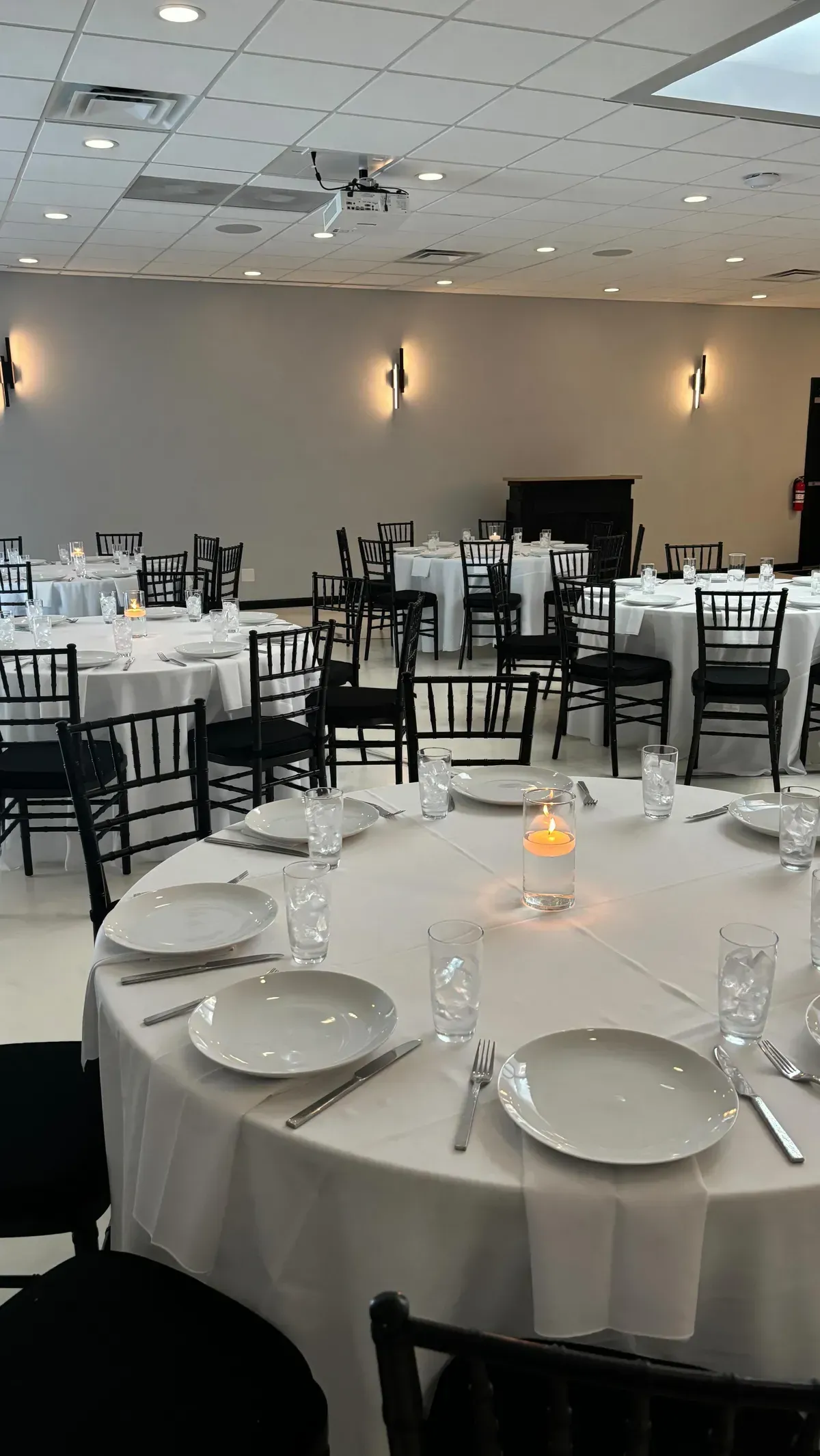 Round dinner table set with plates and glassware for a seated event in Baltimore