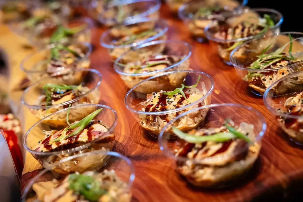 Baltimore Staff Catering Shift Handoff Plan Individual appetizer cups lined up on a wooden table for easy pickup in Baltimore