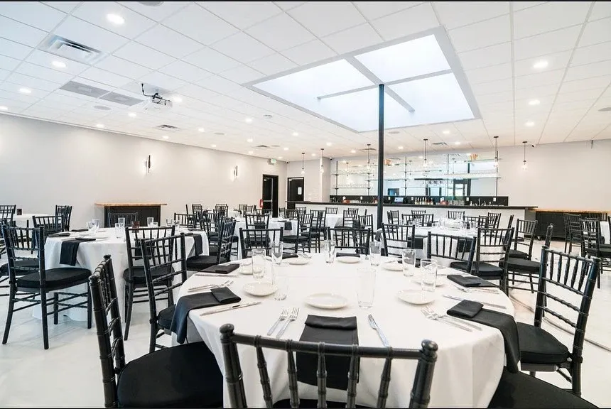Banquet room with round tables and black chairs set before guests arrive in Baltimore