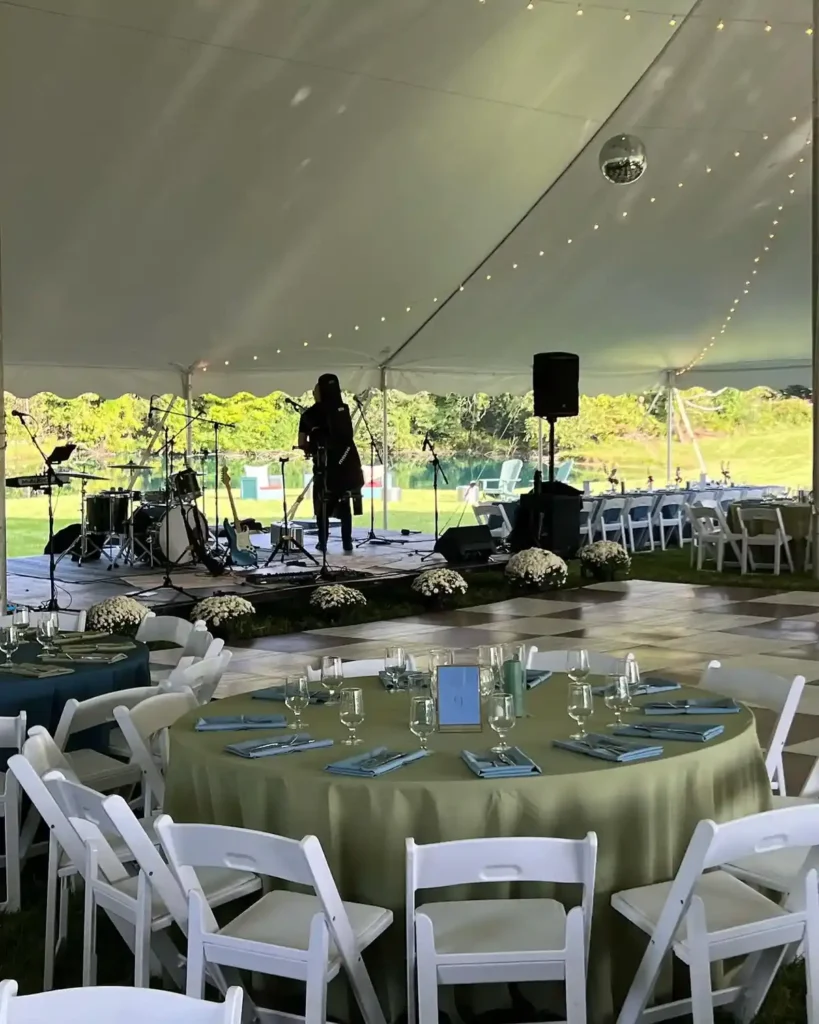 Round tables set under an outdoor tent for a catered reception in Baltimore