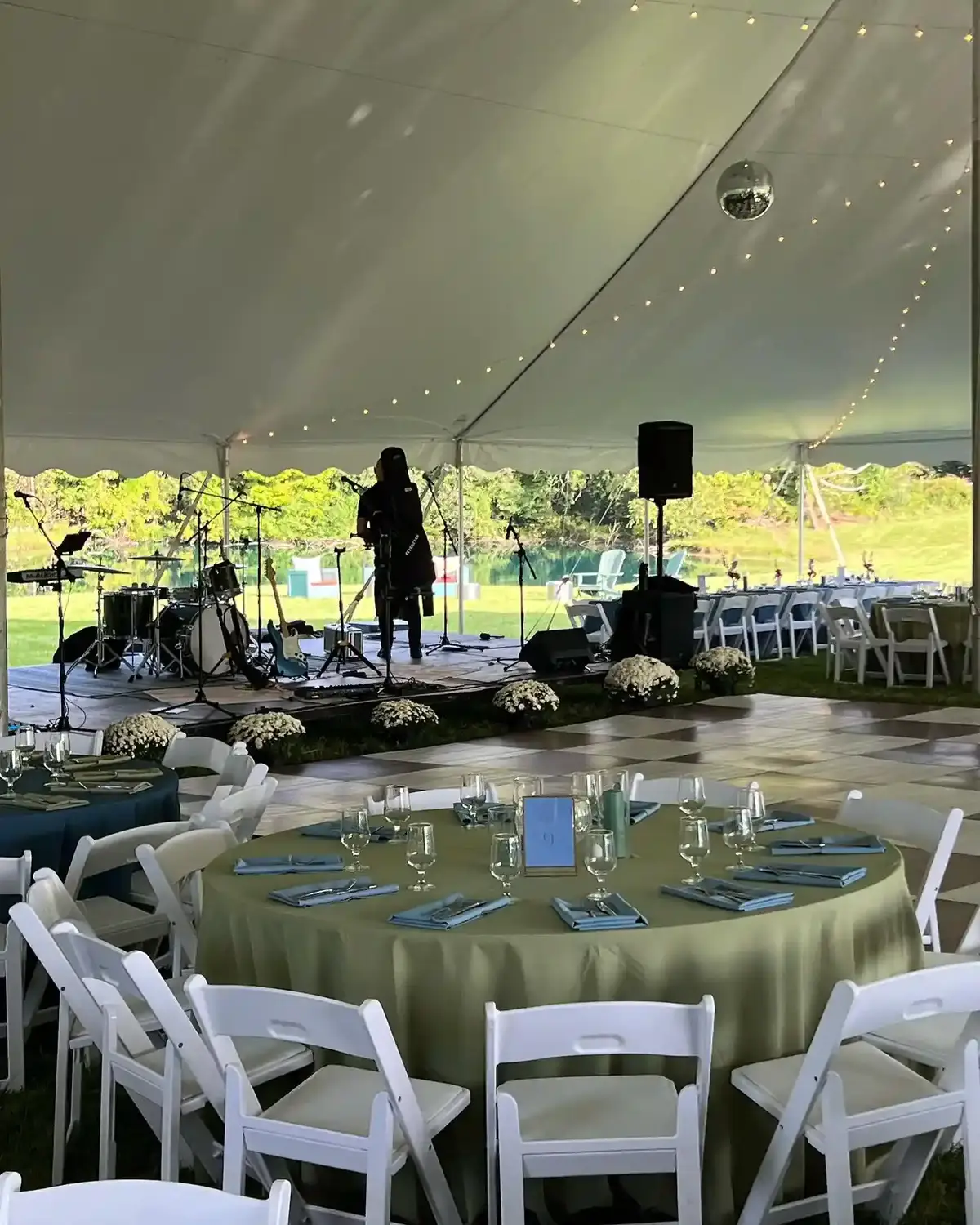 Round tables set under an outdoor tent for a catered reception in Baltimore