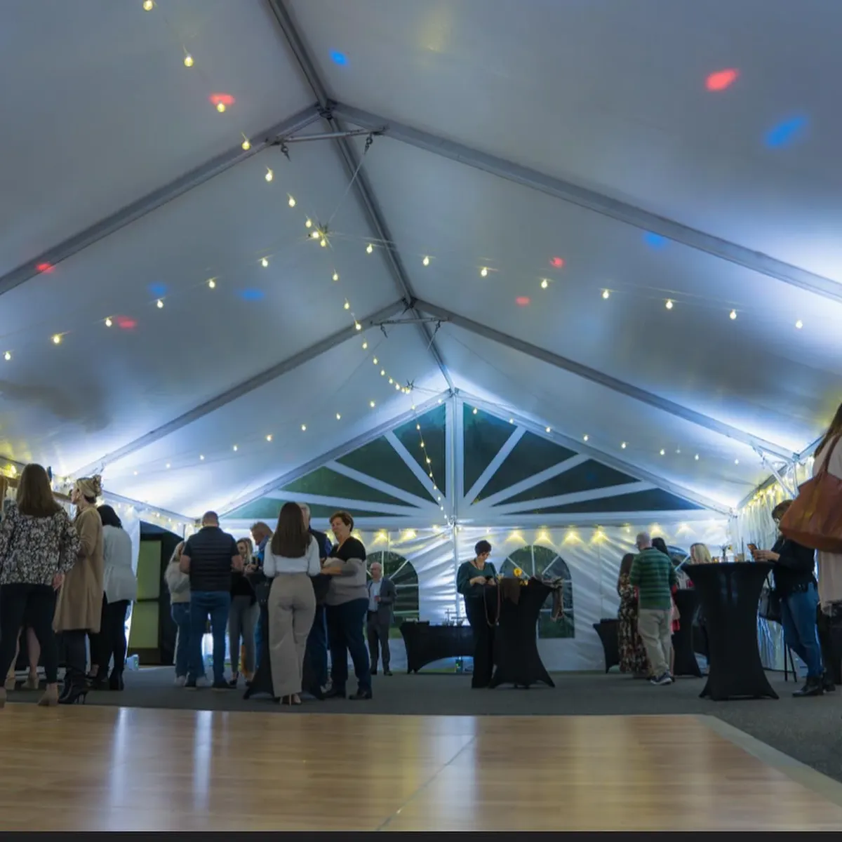 Event tent with string lights and a dance floor ready for guests in Baltimore