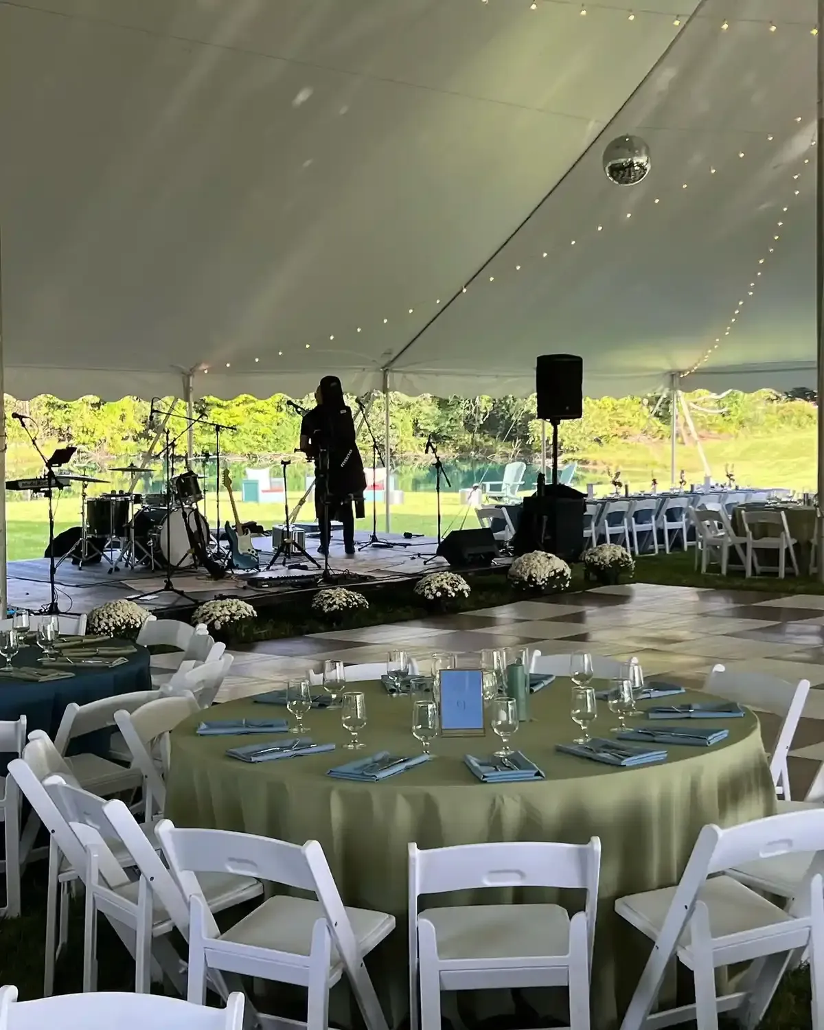 Round tables set under an outdoor tent for a catered waterfront reception in Baltimore